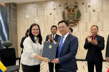El vicepresidente de la Unión de Organizaciones de Amistad de Vietnam Dong Huy Cuong y la presidenta del Instituto Simón Bolívar por la Paz y la Solidaridad entre los Pueblos, Rosa Eekhout Gómez, firman un memorando de entendimiento sobre cooperación bilateral. (Fotografía: Embajada de Vietnam en Venezuela)