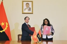 El ministro Nguyen Kim Son y la ministra Maria do Rosário Bragança intercambian el acta de la reunión. (Fotografía: dangcongsan.vn)