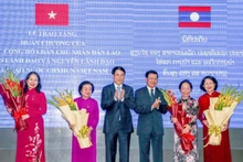 El presidente vietnamita, Luong Cuong, y el secretario general del Partido Popular Revolucionario y presidente de Laos, Thongloun Sisoulith, felicitan a la vicepresidenta Vo Thi Anh Xuan y a las ex subjefas de Estado Truong My Hoa, Nguyen Thi Doan y Dang Thi Ngoc Thinh. (Fotografía: Nhan Dan)