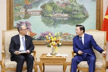 El vice primer ministro de Vietnam Tran Hong Ha recibe al director general de Power China, Wang Bin. (Fotografía: VNA)
