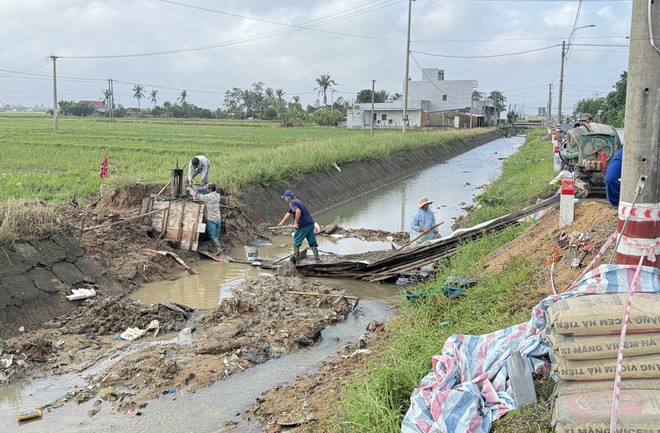 Trabajadores se apresuran a reparar las secciones dañadas del Canal Chinh Nam debido a las fuertes lluvias e inundaciones. (Foto: VNA)