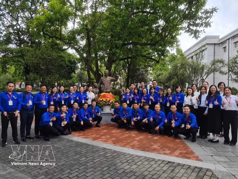 Jóvenes vietnamitas posan para una fotografía junto a la estatua del "Tío Ho" en la Universidad de Guangxi. (Foto: VNA)