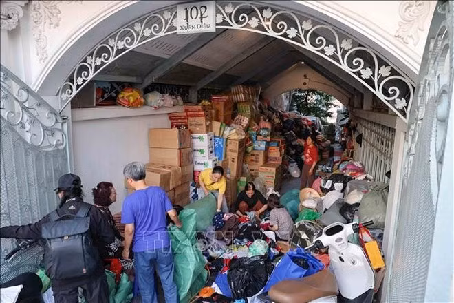 Voluntarios clasifican, empacan e inventarian los suministros de socorro en el punto de recepción de Xuan Dieu 102 (Hanói). (Foto: VNA)
