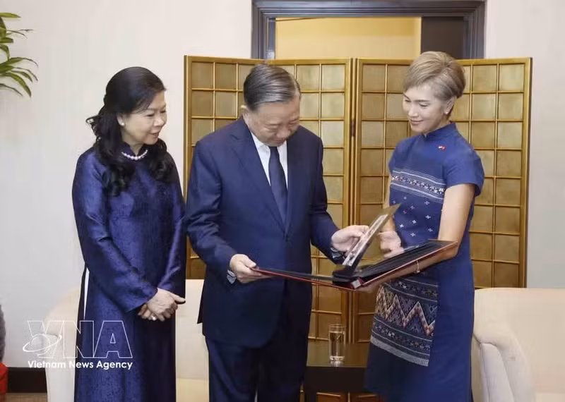 La ministra de Desarrollo Digital e Información de Singapur, Josephine Teo, entrega al secretario general del PCV y presidente de Vietnam, To Lam, y a su esposa, un álbum de fotos que recopila las actividades del mandatario vietnamita y su cónyuge en Singapur. (Foto: VNA)