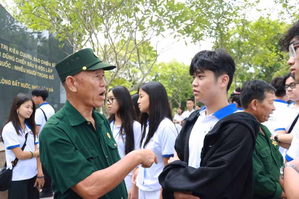 Jóvenes y estudiantes vietnamitas residentes en el extranjero conversan con veteranos de guerra.