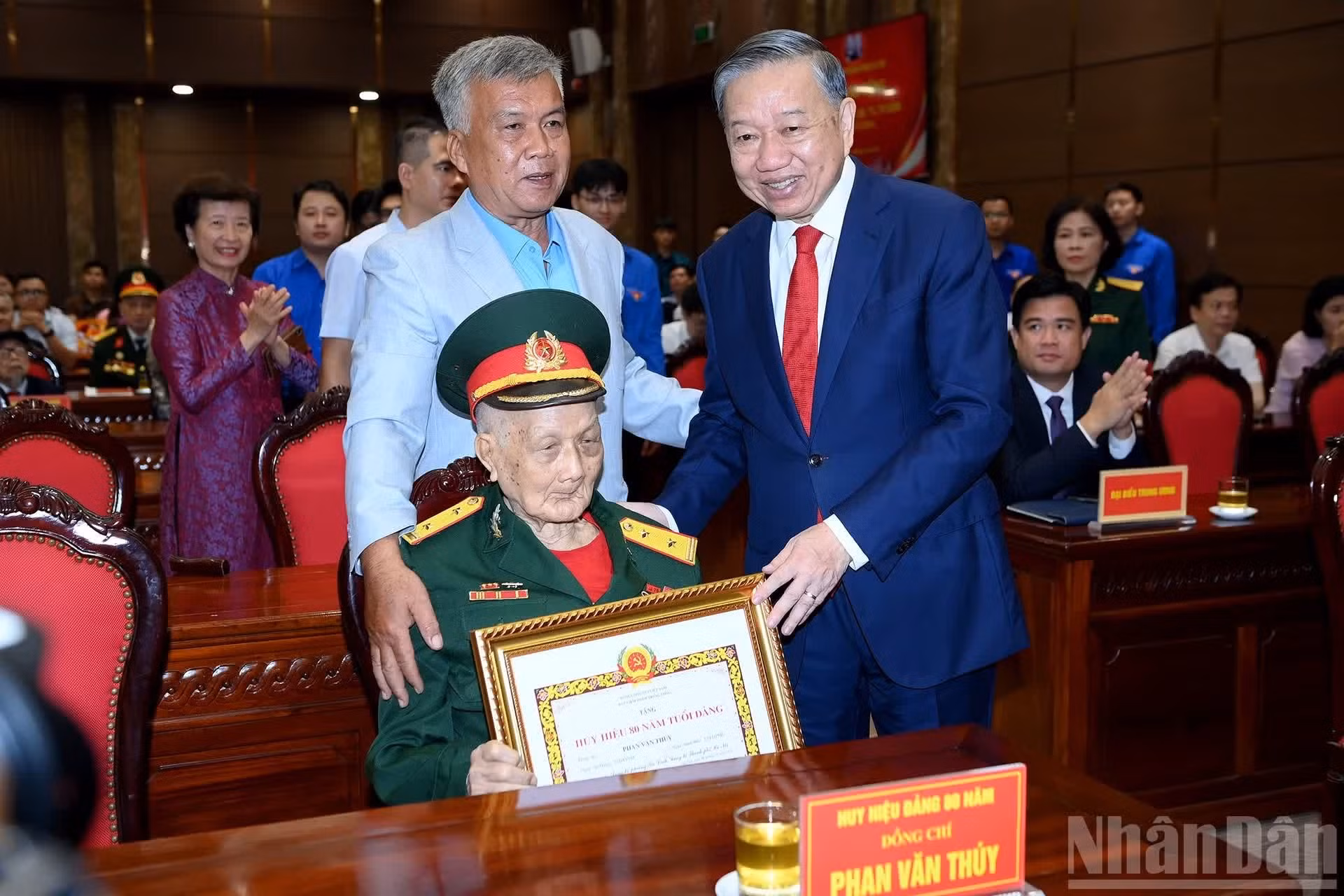 El máximo dirigente del país felicita a un miliante condecorado por sus 80 años de afiliación al Partido.