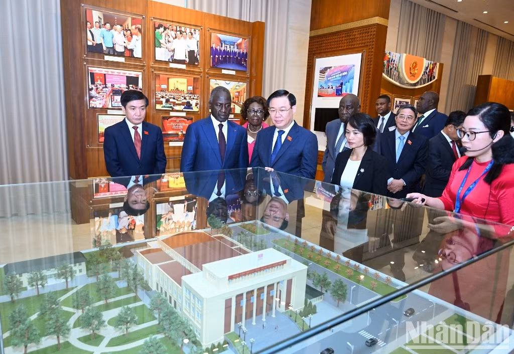 Delegados observan objetivos exhibidos en la sala memorial.