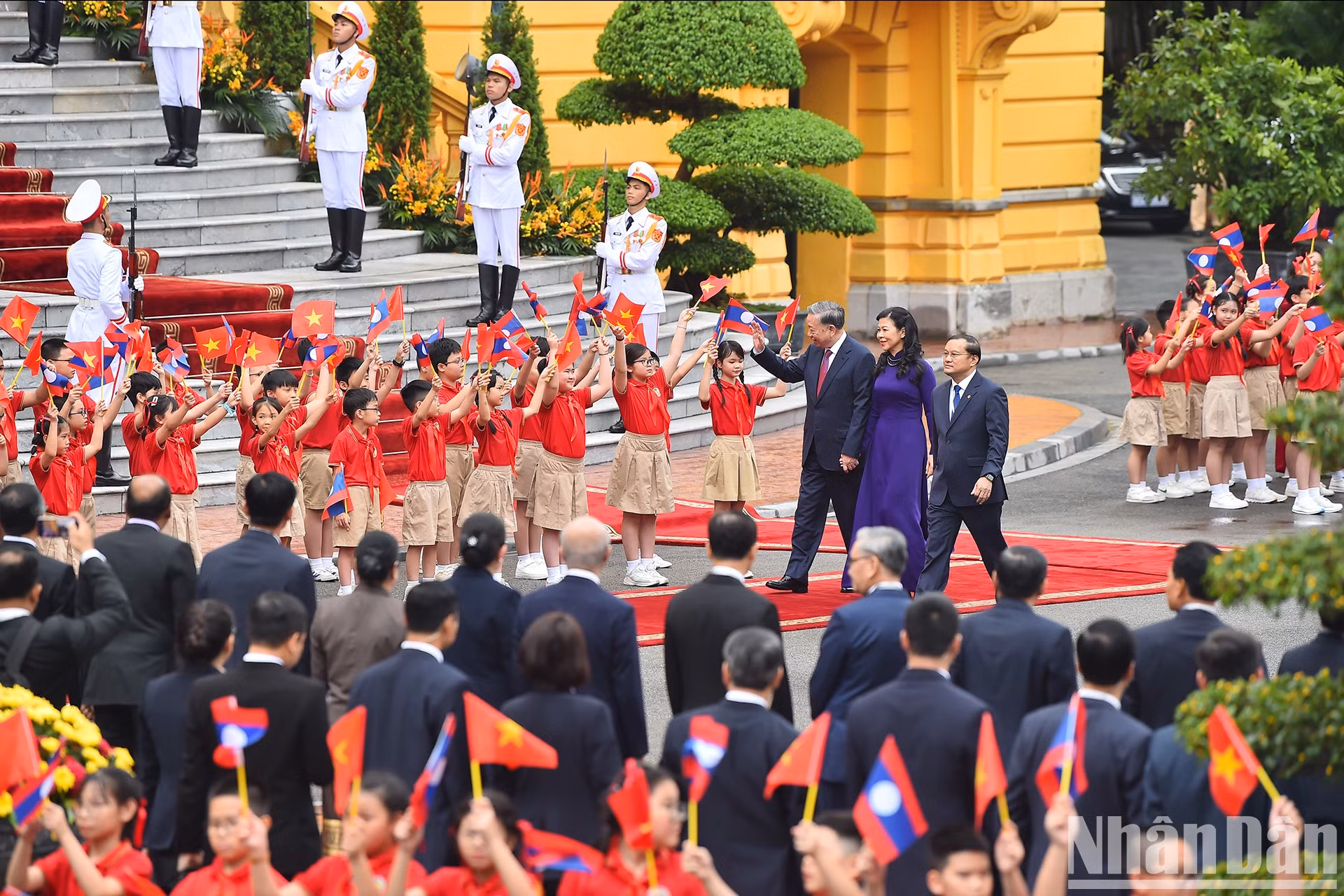 Niños hanoyenses saludan a To Lam y su cónyuge, Ngo Phuong Ly.