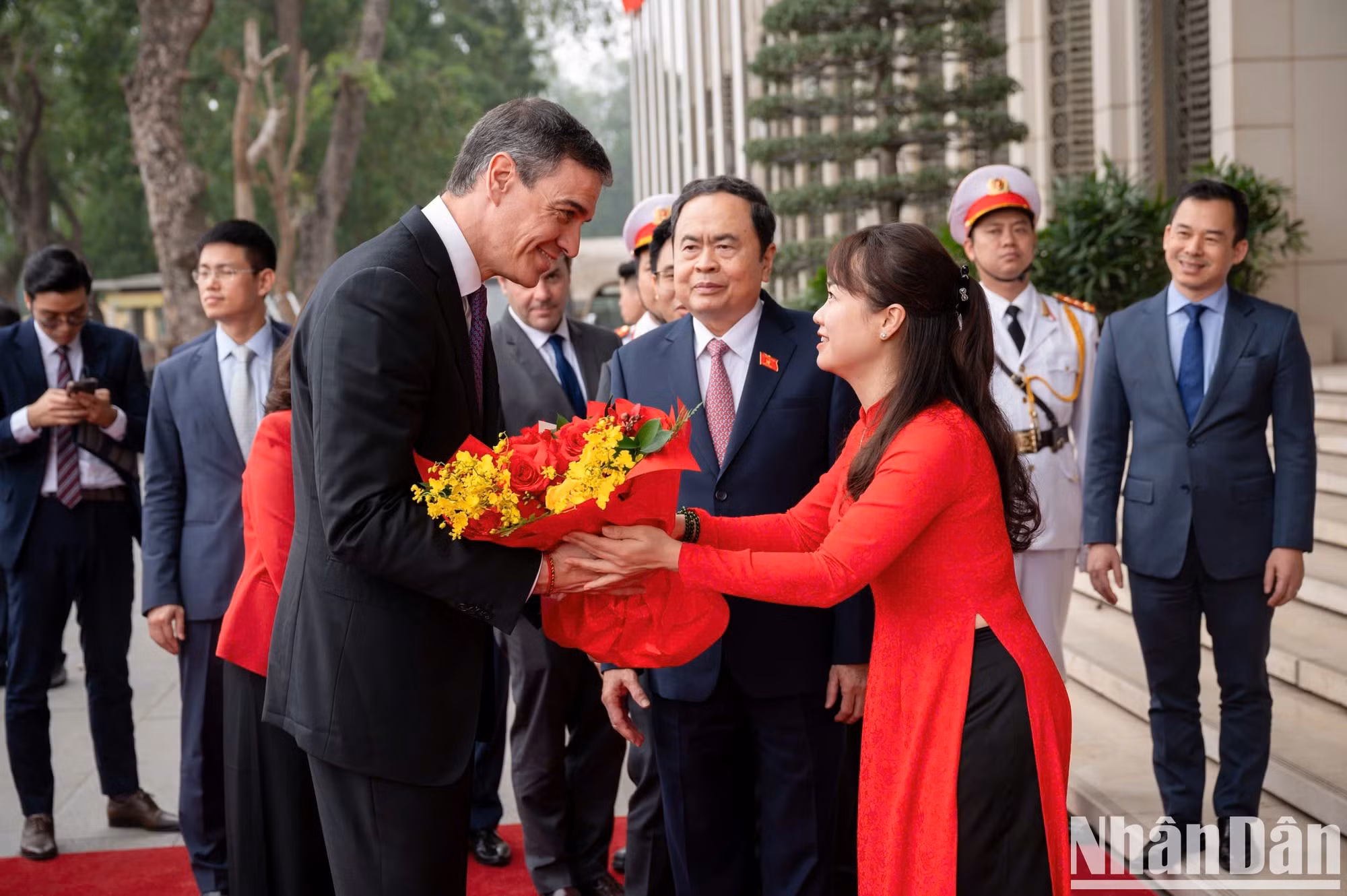 El jefe de Gobierno español recibe flores de bienvenida del personal de la Casa Parlamentaria, sede del cuerpo legislativo vietnamita.