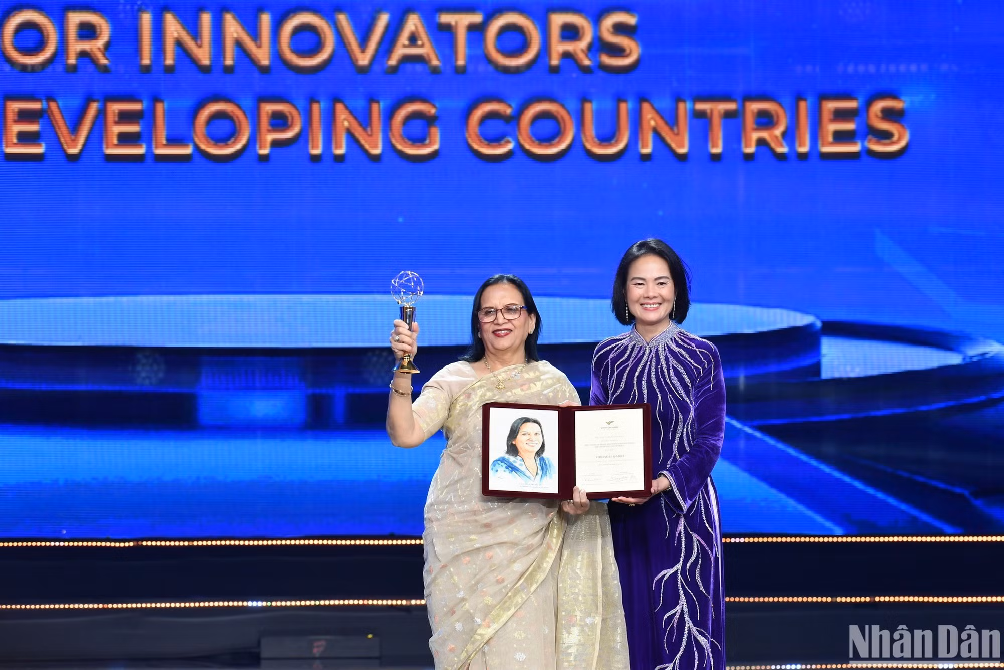 La profesora Nguyen Thuc Quyen, presidenta del Consejo Preliminar de VinFuture, entrega el trofeo y el certificado al ganador del Premio Especial para científicos de países en desarrollo, Firdausi Qadri, por el proyecto «Innovación y mejora de las formas de vacuna para la profilaxis oral del cólera en los países en desarrollo».