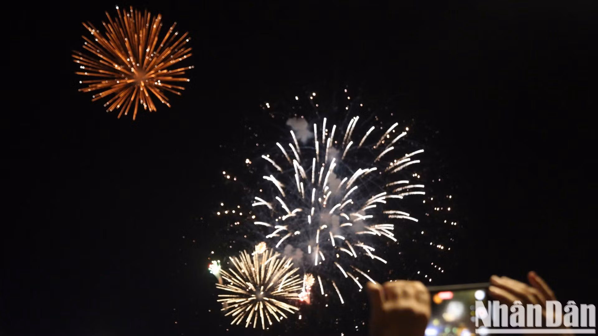 Los habitantes locales capturan el momento en que los fuegos artificiales iluminan el cielo.
