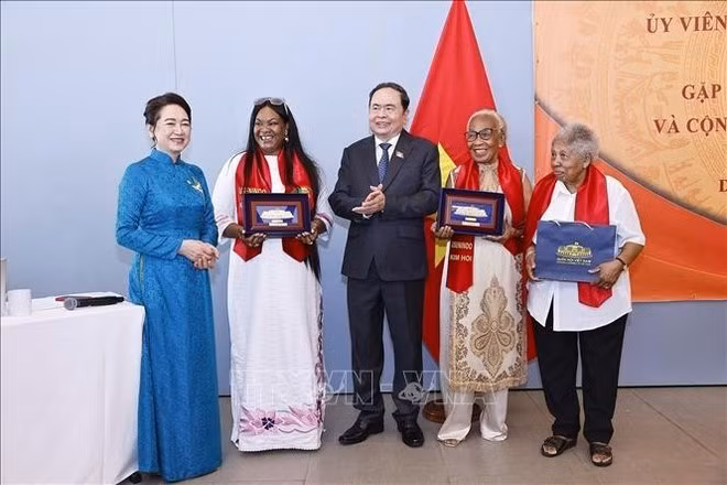 El presidente de la Asamblea Nacional de Vietnam, Tran Thanh Man (centro), y su esposa (primera a la izquierda) entregan obsequios a la comunidad vietnamita en Senegal. (Foto: VNA)