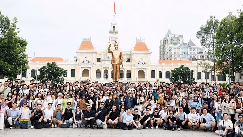 Un grupo de turistas MICE de Indonesia se toma fotos en el Parque del Monumento al Presidente Ho Chi Minh, en la homónima ciudad vietnamita, el 6 de mayo de 2025. (Foto: Nhan Dan)