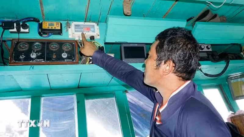 Un pescador chequea dispositivos de monitoreo satelital de rutas antes de zarpar. (Foto: VNA)