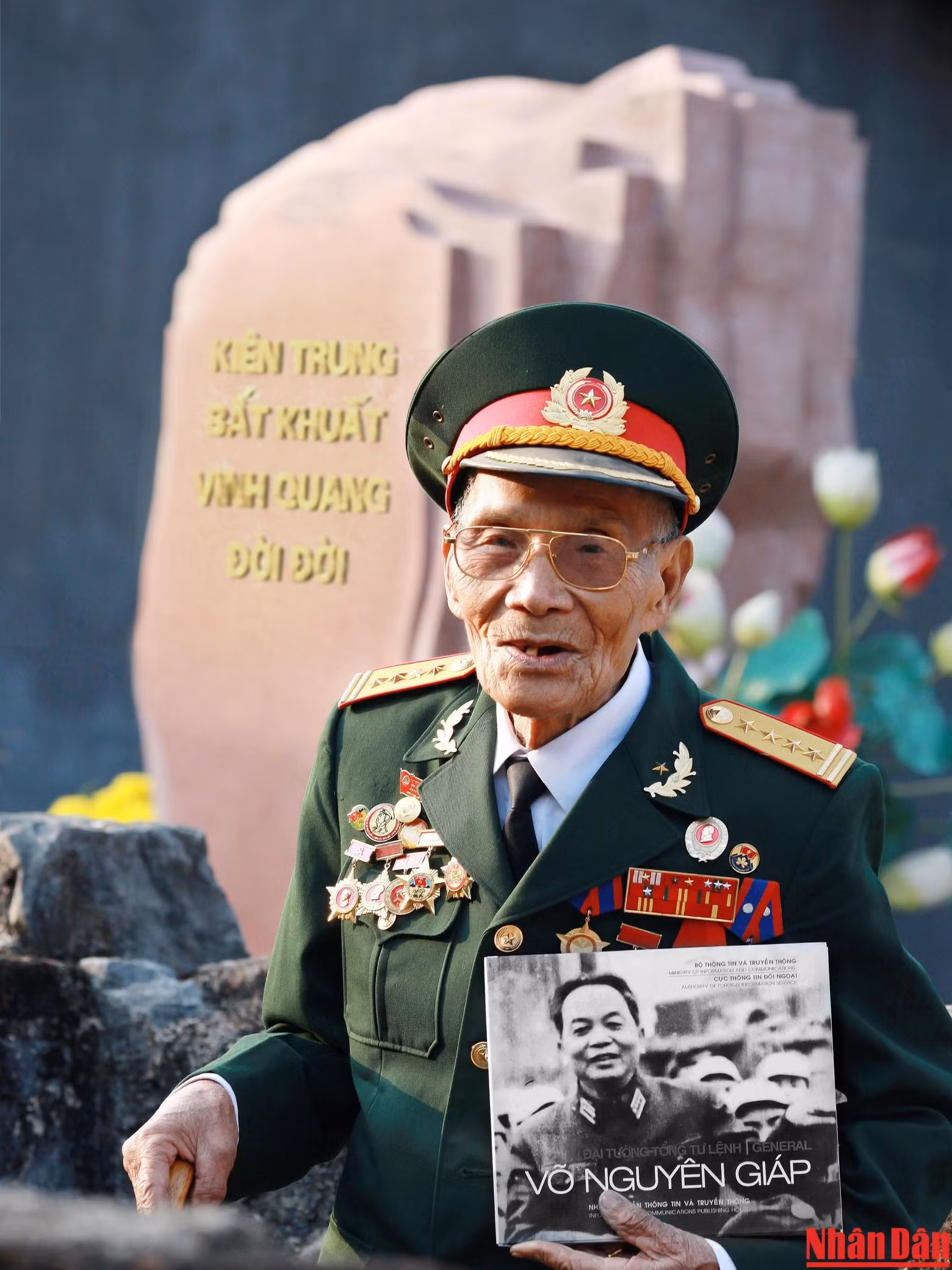 Un veterano revolucionario, con un libro sobre el General Vo Nguyen Giap en la mano, cuenta a los jóvenes sobre el ingenioso estratega militar vietnamita.