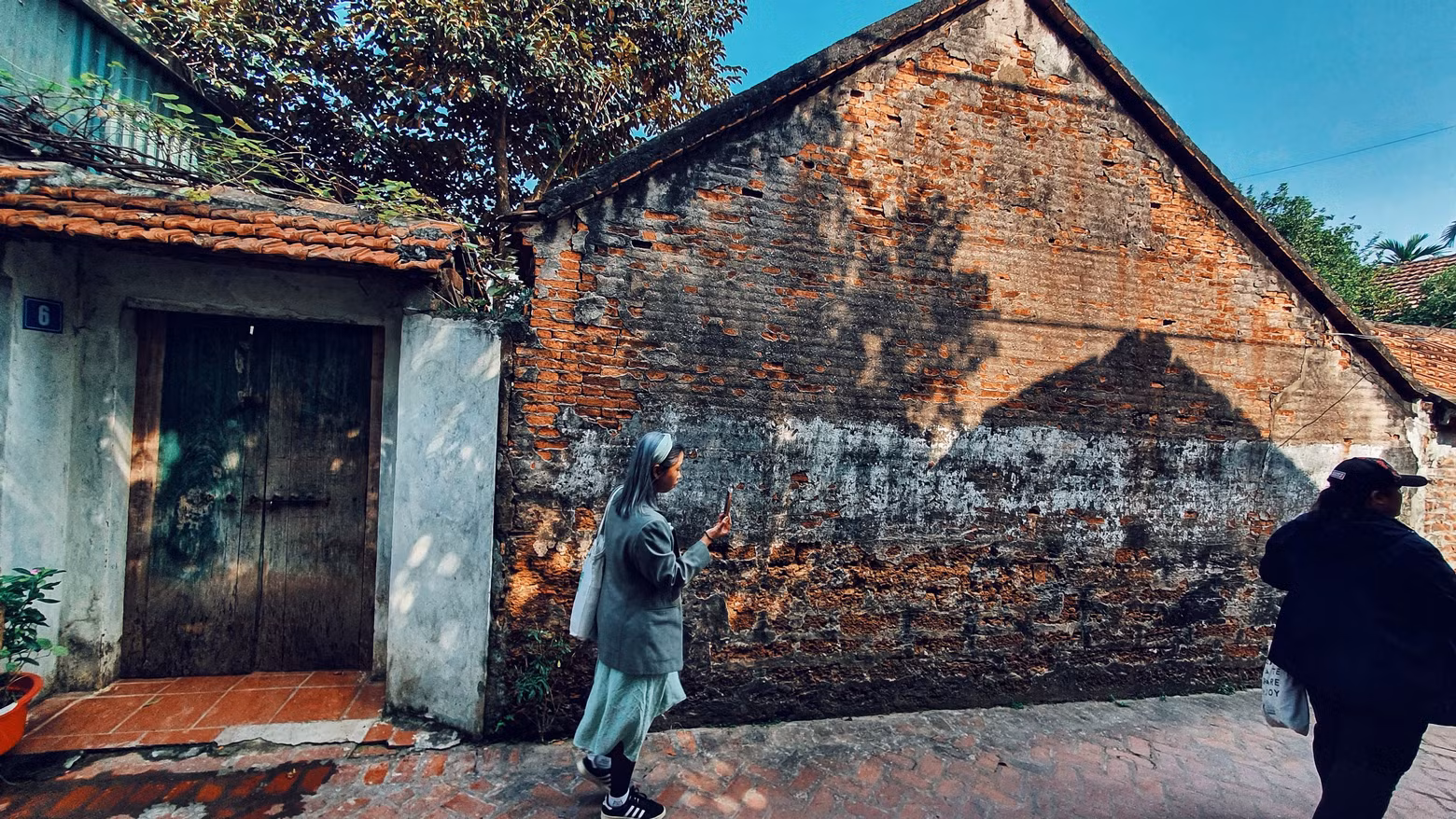 Los turistas visitan a la aldea en días previos del Tet.