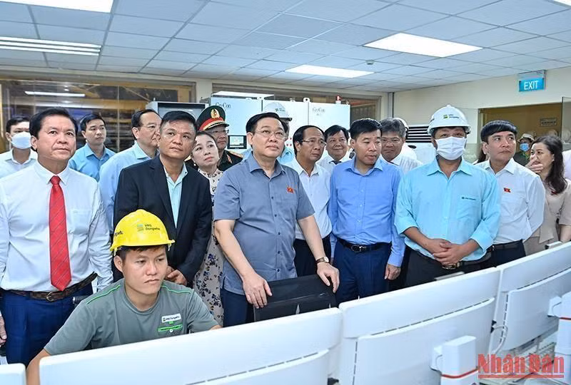 Los visitantes observan la línea de producción en la fábrica.