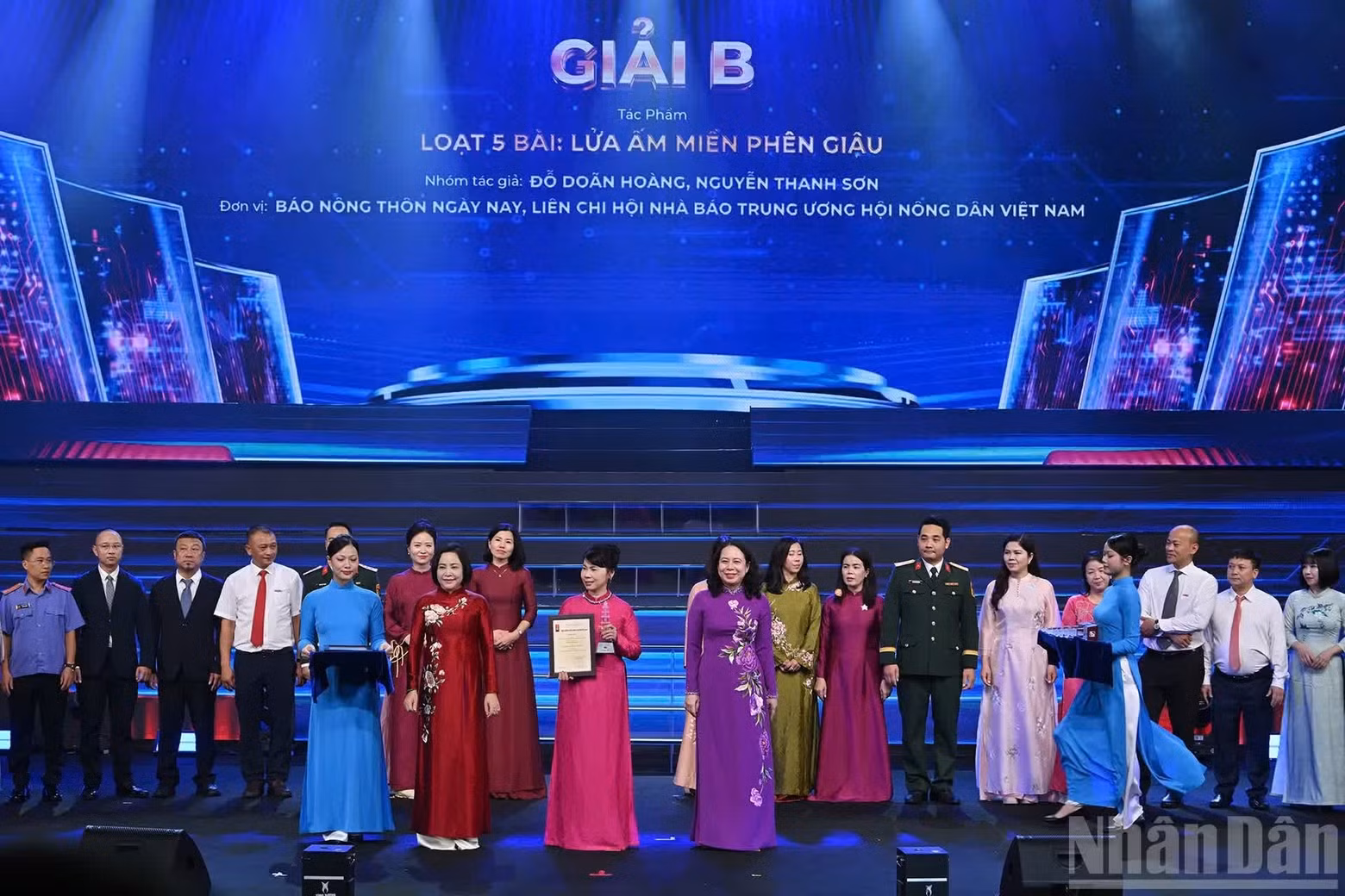 La vicepresidenta Vo Thi Anh Xuan y la vicepresidenta de la Asamblea Nacional, Nguyen Thi Thanh, entregan premios B a representantes de los grupos de autores galardonados de Nhan Dan.