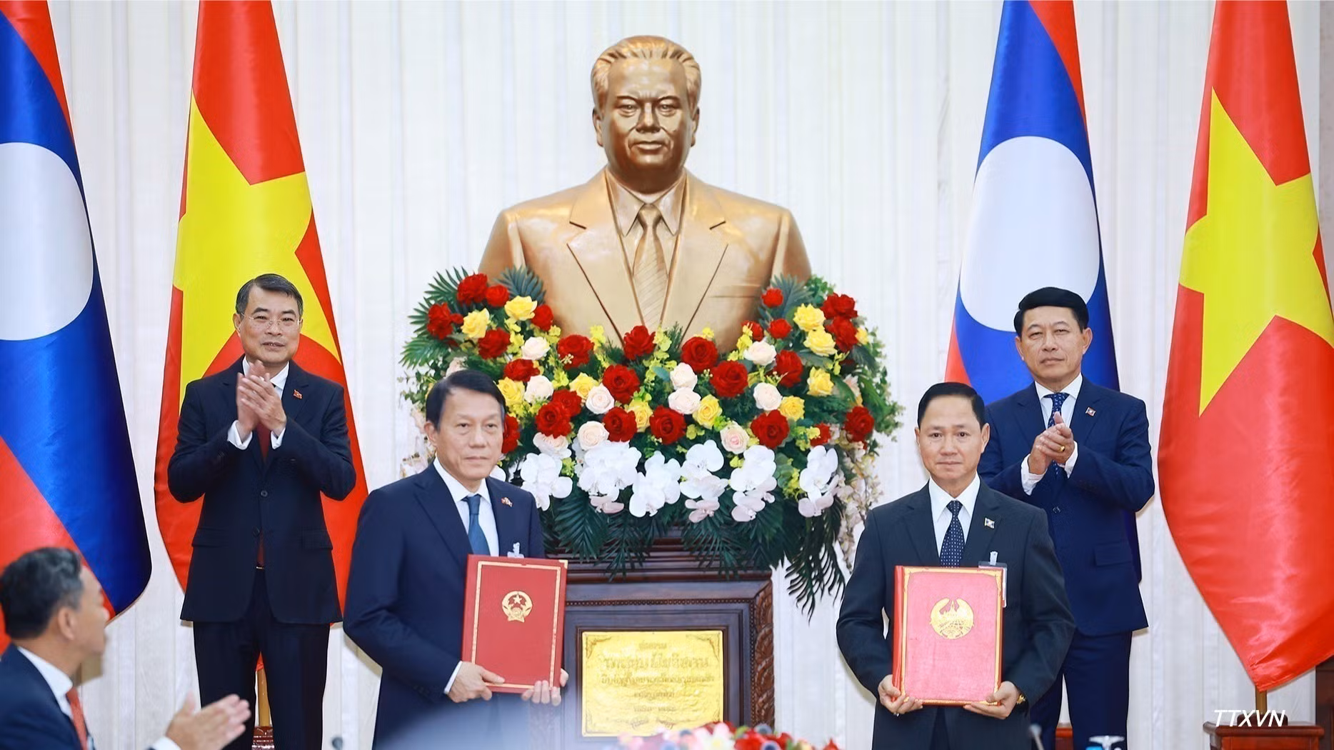 Los primeros ministros Le Minh Hung y Saleumxay Kommasith presencian el intercambio del acta de entrega del sistema de gestión de la población y de identificación ciudadana en Laos entre los ministerios de Seguridad Pública de ambos países. (Foto: DUONG GIANG/VNA)