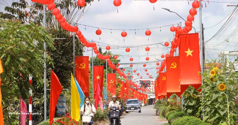 Una carretera rural en la comuna de Tra Con, provincia de Vinh Long, engalanada con banderas y flores, refleja el ambiente festivo y de expectación ante la próxima jornada electoral. (Foto: VNA)